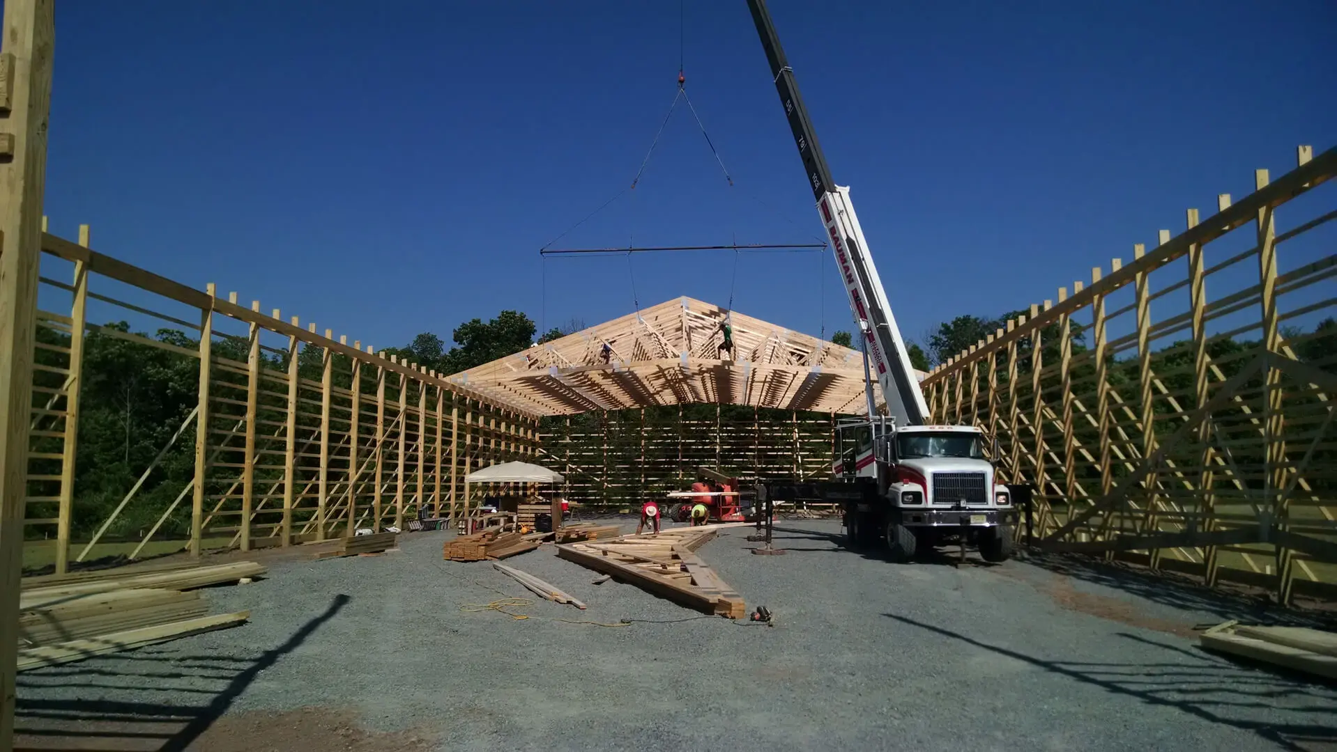 A crane is lifting a wooden structure into place.