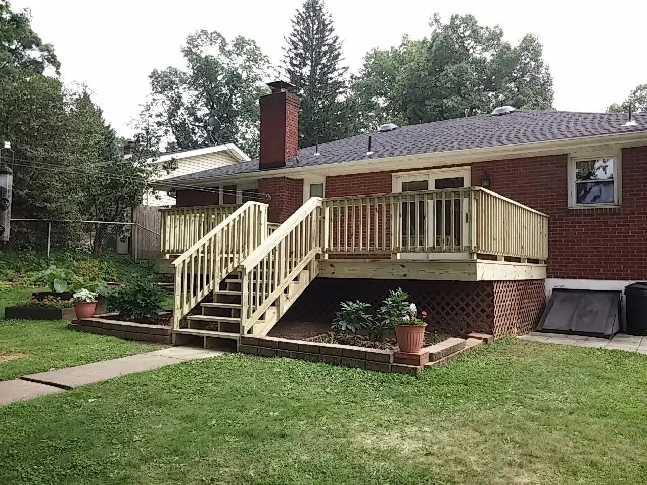 A house with stairs leading to the front of it.