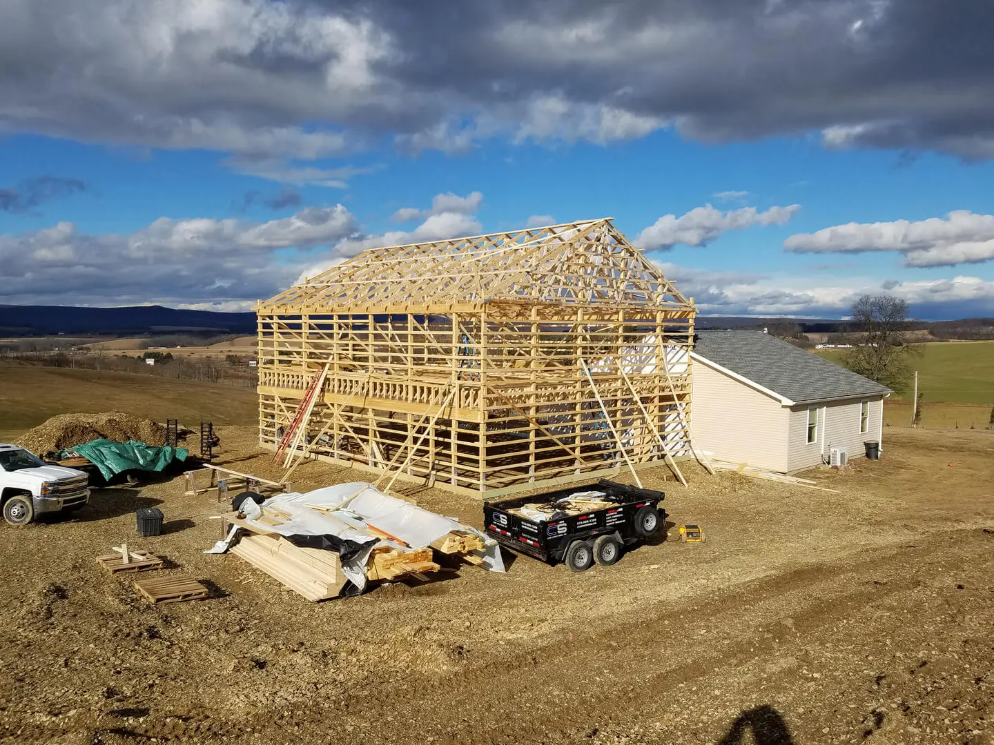 A building being built on top of dirt ground.