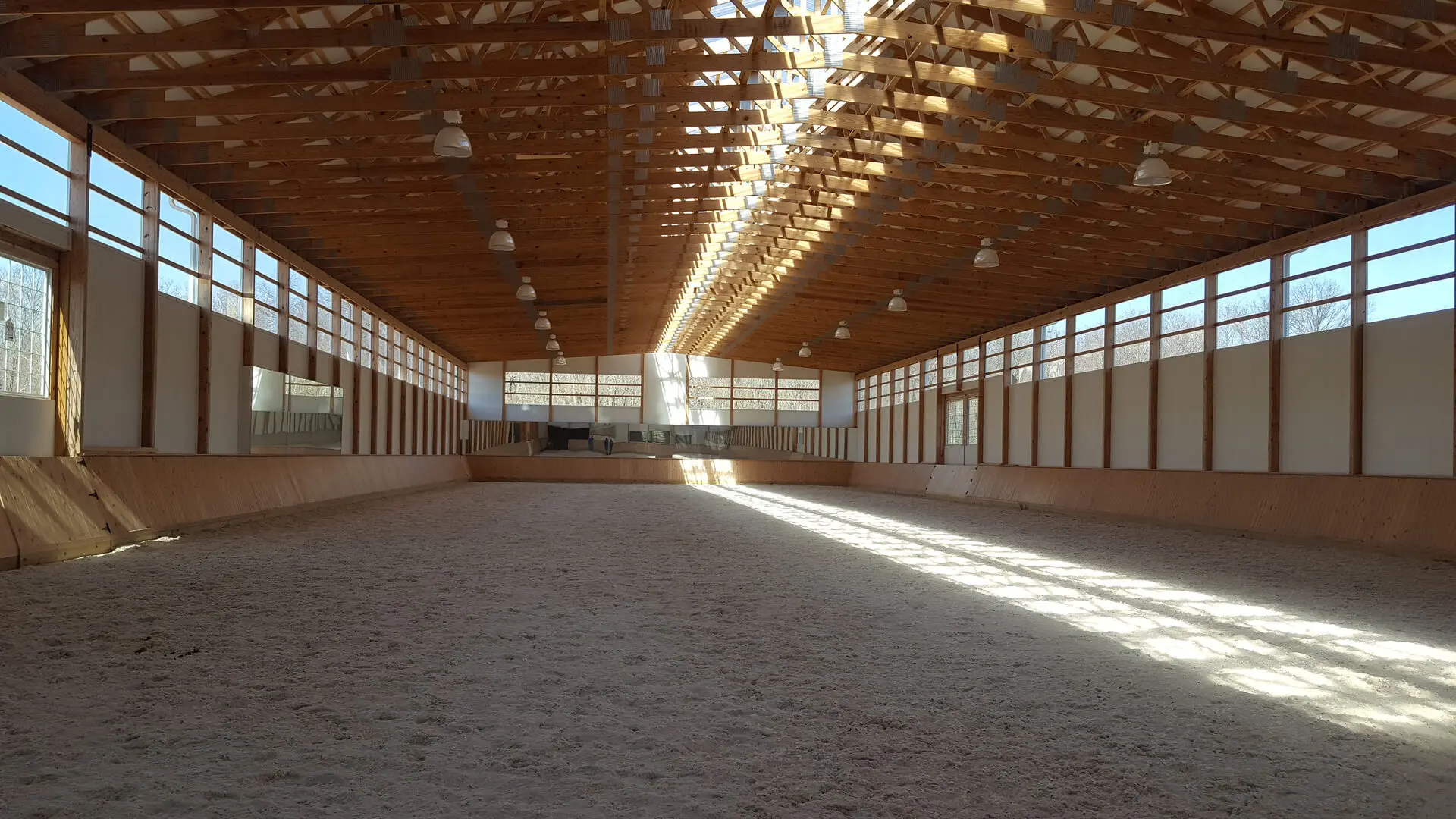 A large indoor arena with many stalls and lights.