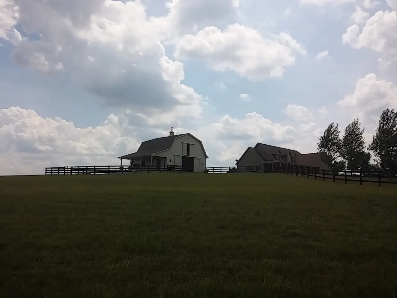 A barn sitting in the middle of a field.