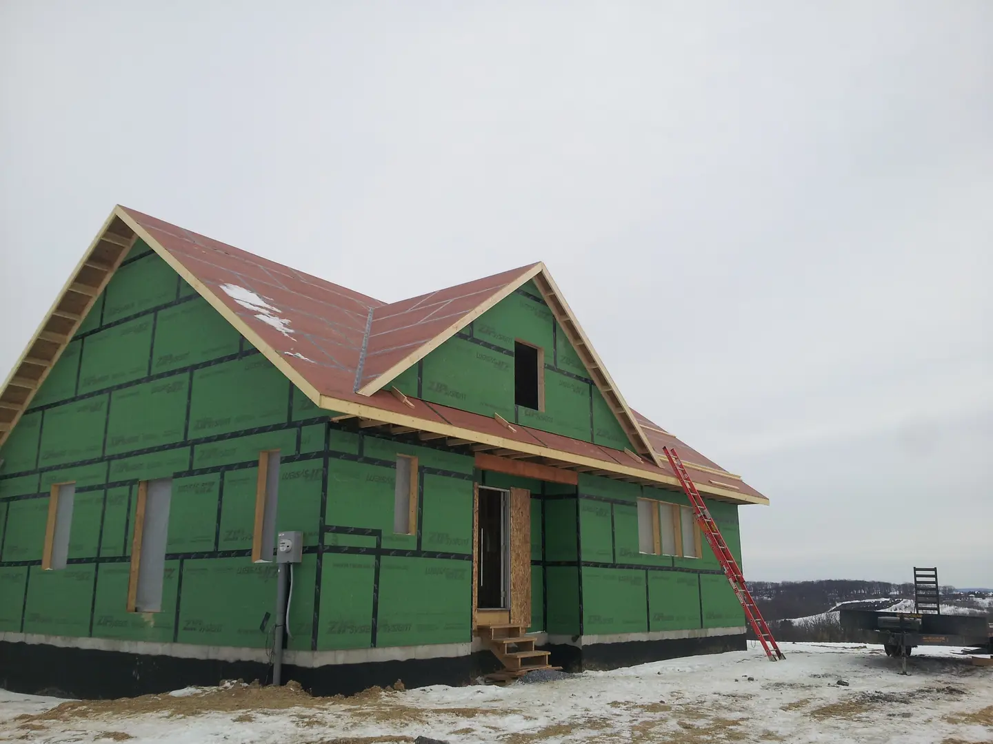 A green house with red roof and windows