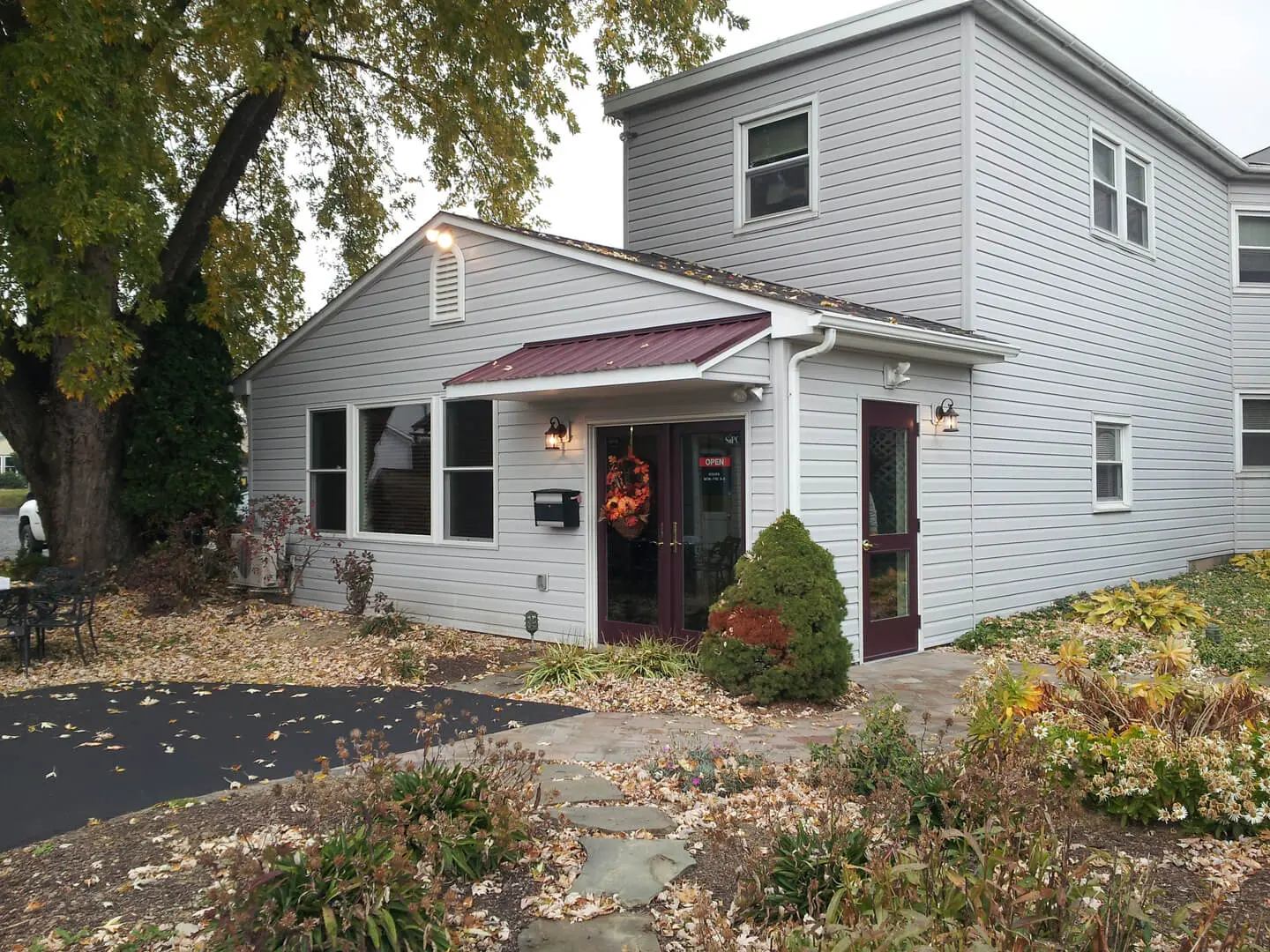 A white house with a red roof and door.