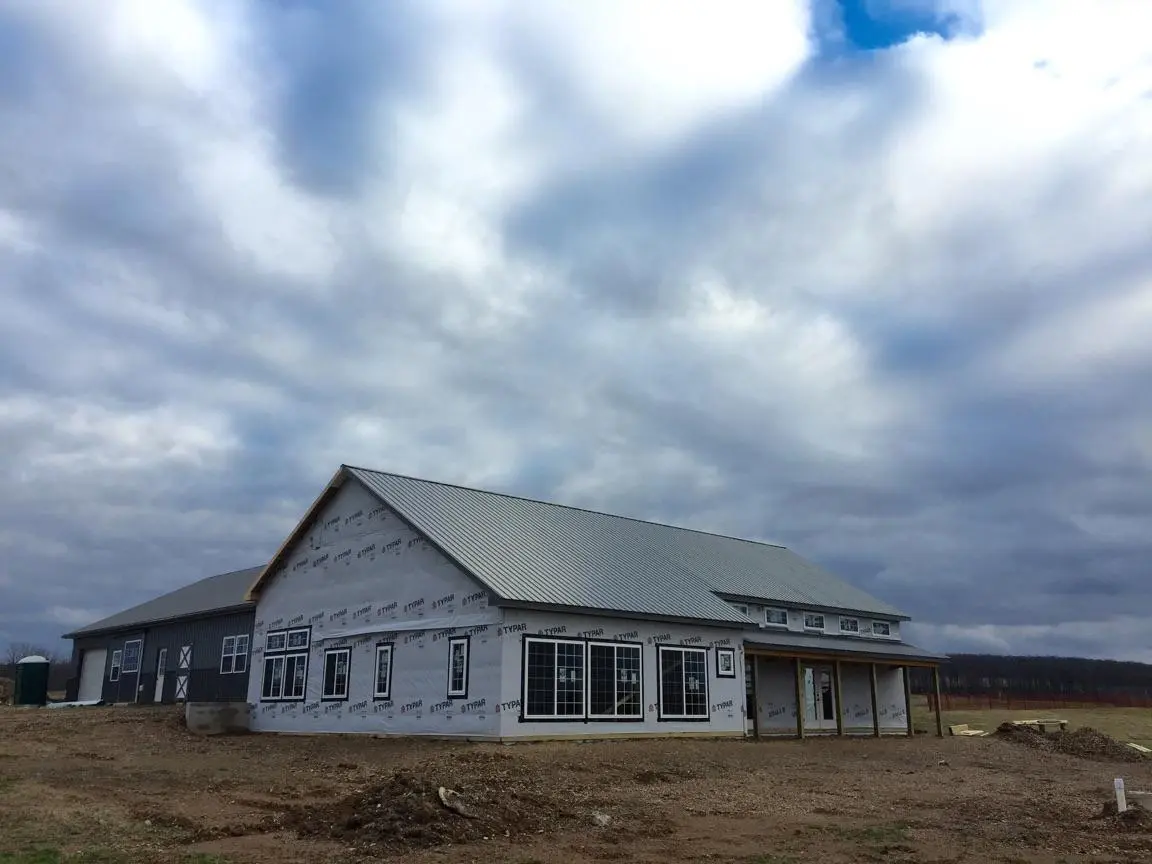 A building that is under construction in the dirt.