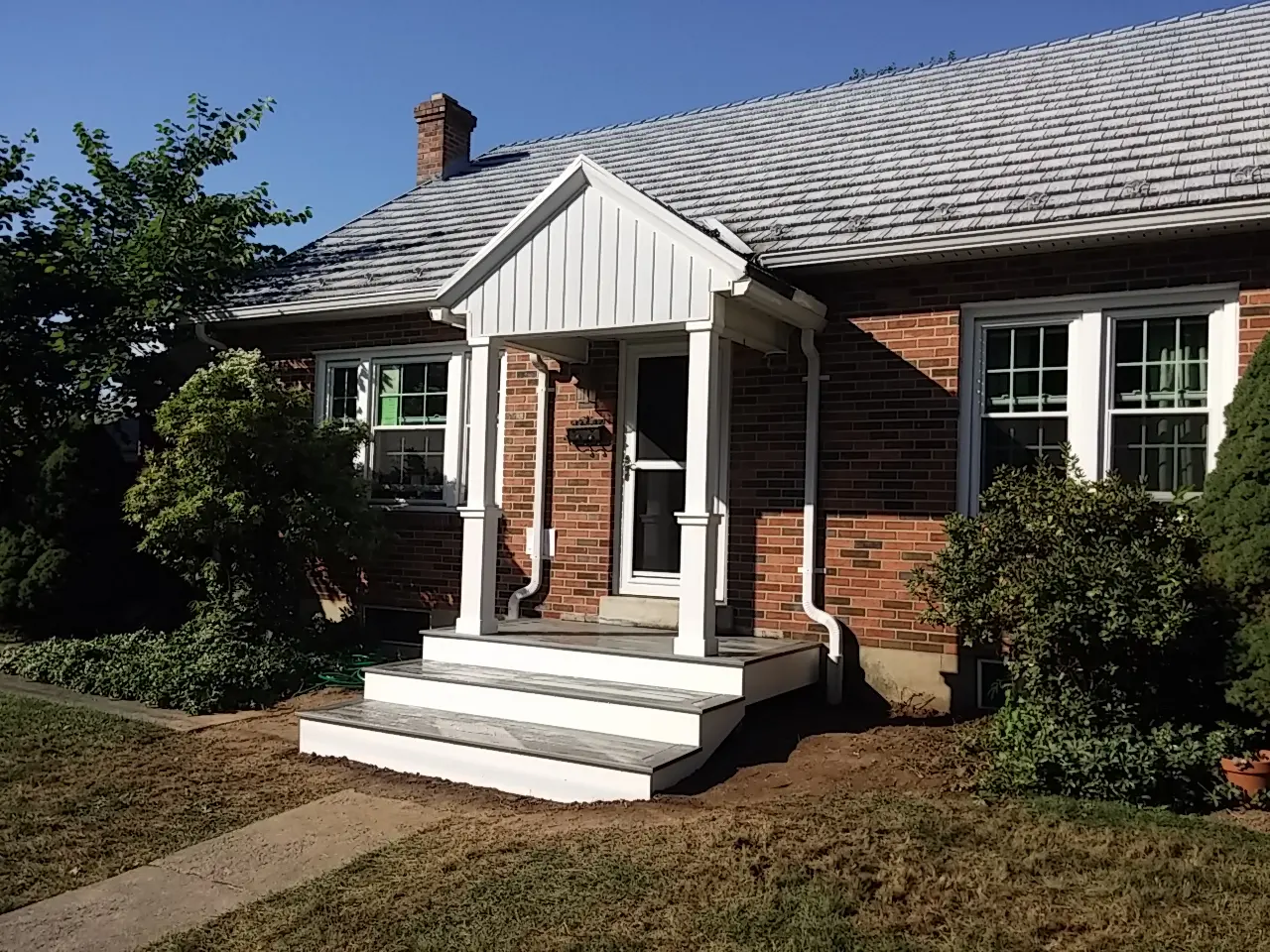 A house with steps leading to the front door.