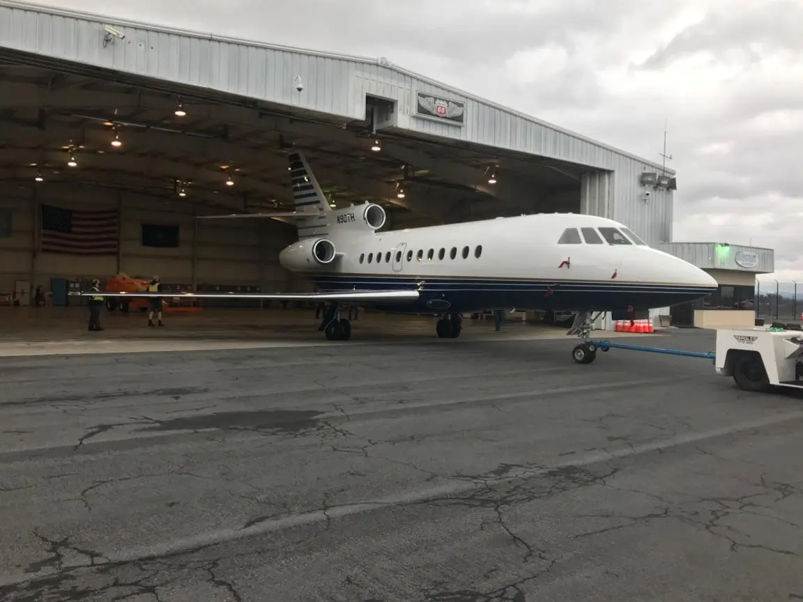 A large white airplane sitting on top of an airport tarmac.