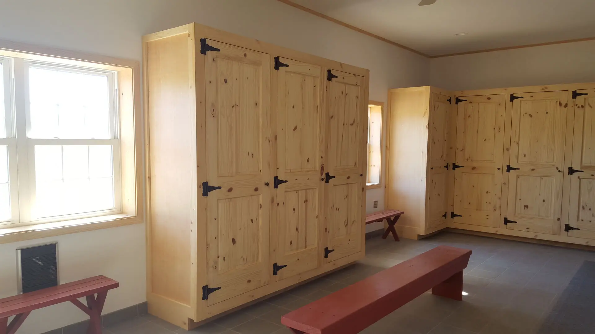 A room with several wooden cabinets and benches.