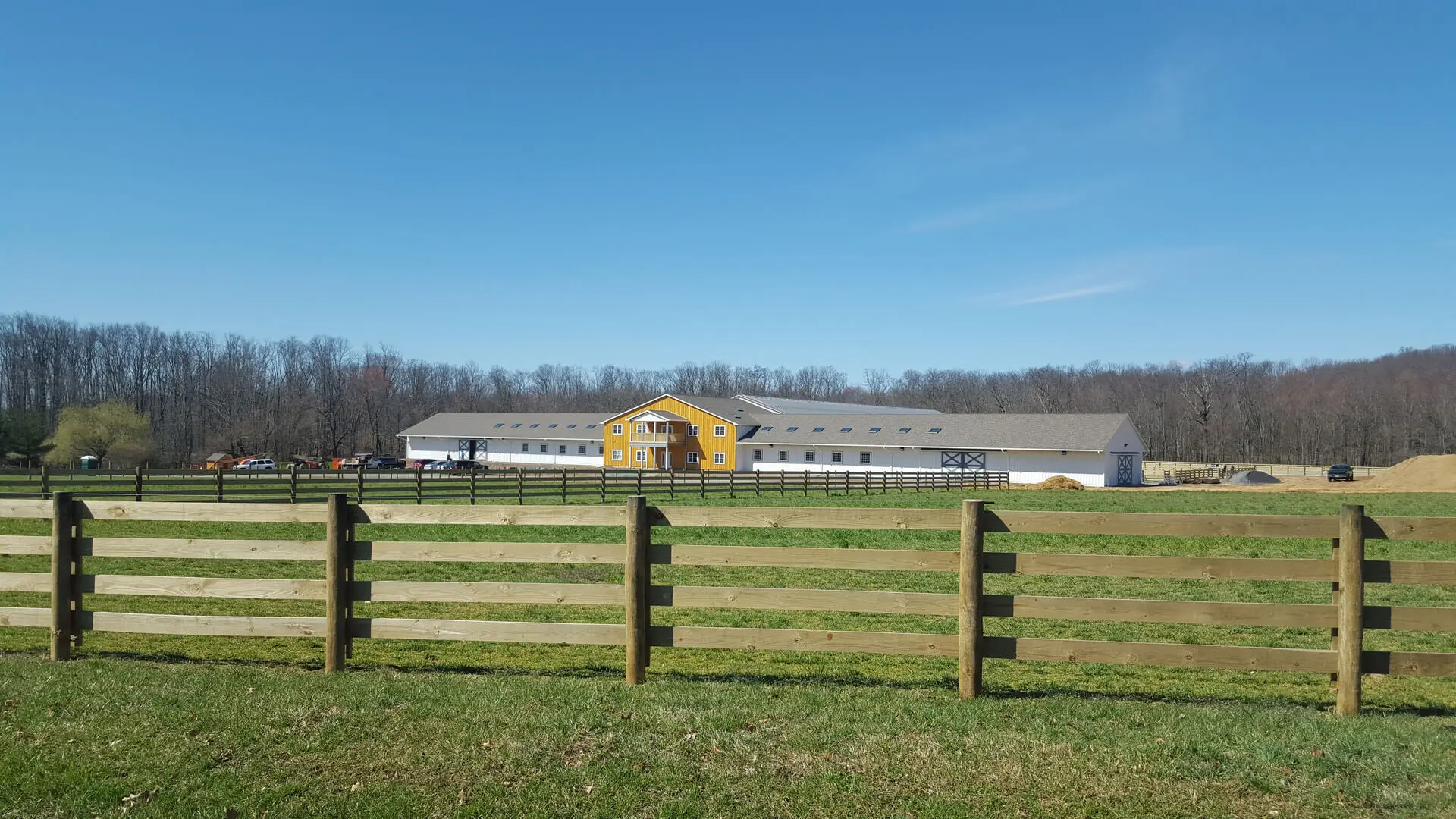 A fence in the middle of an open field.