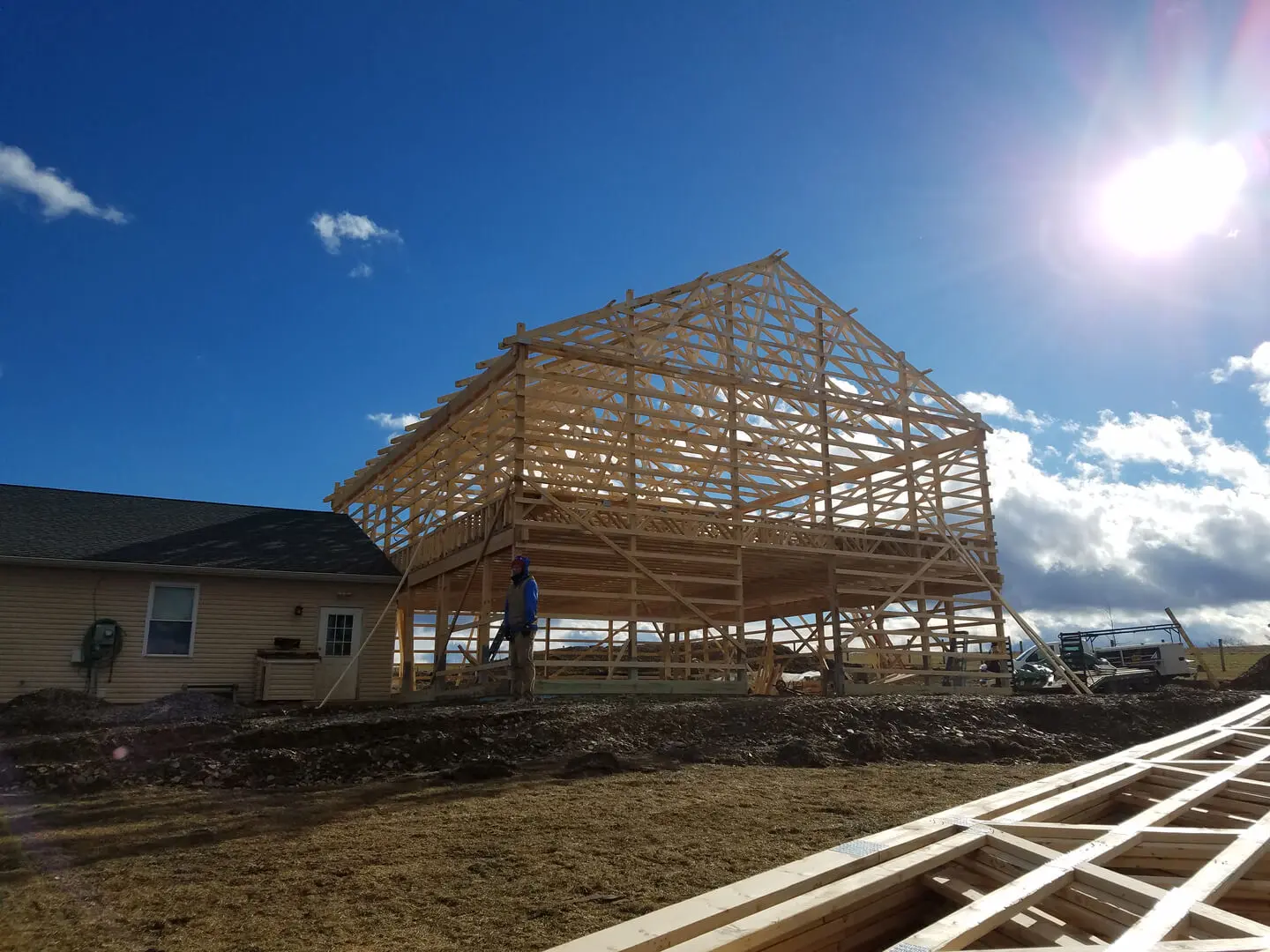 A building under construction with a person standing in the background.