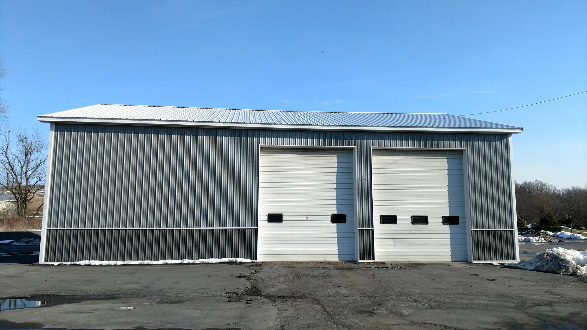 A large building with two doors and a sky background