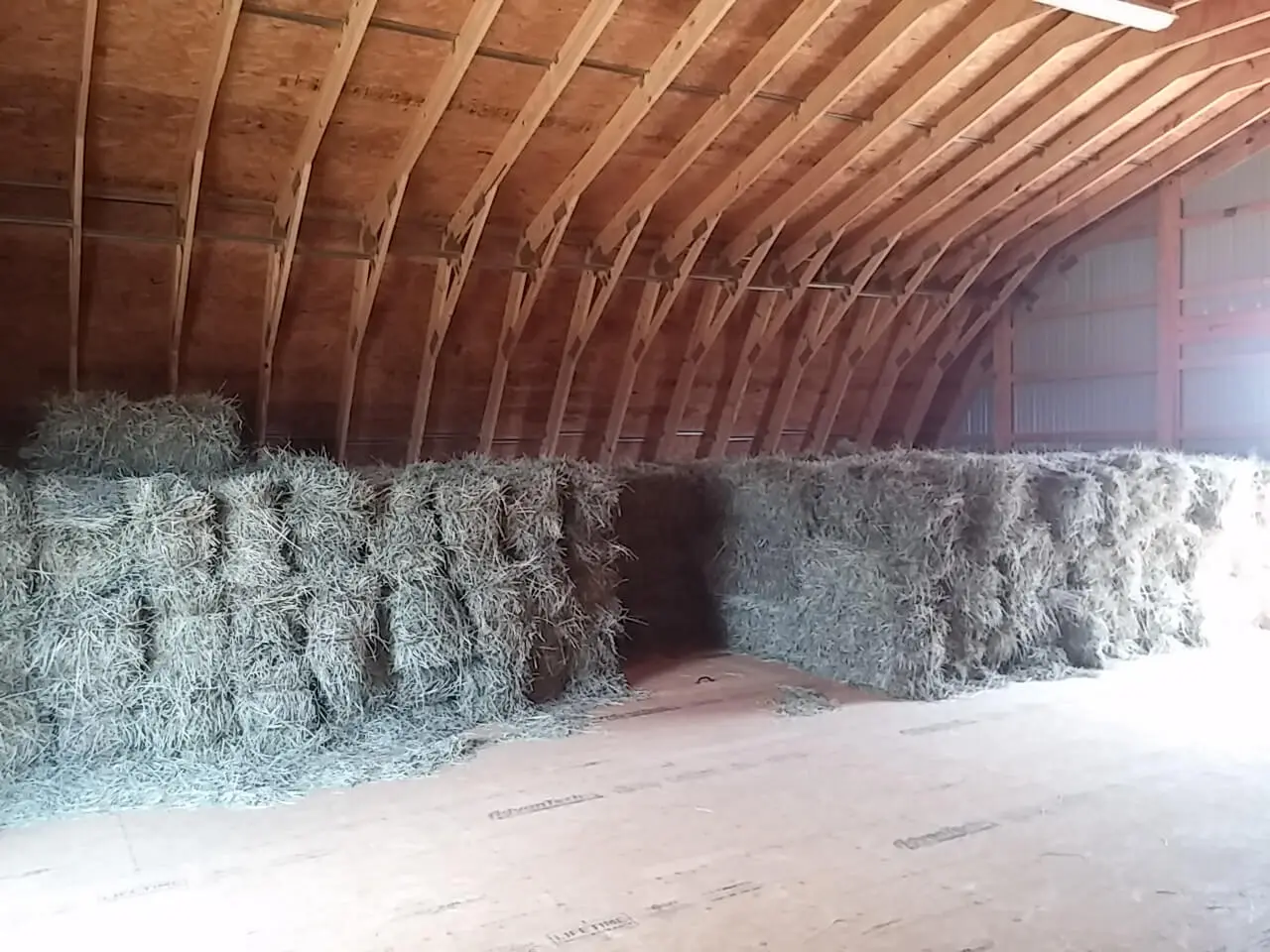 A room filled with hay in the middle of it.