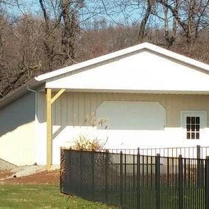 A white house with a fence around it