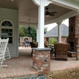 A porch with chairs and tables in it